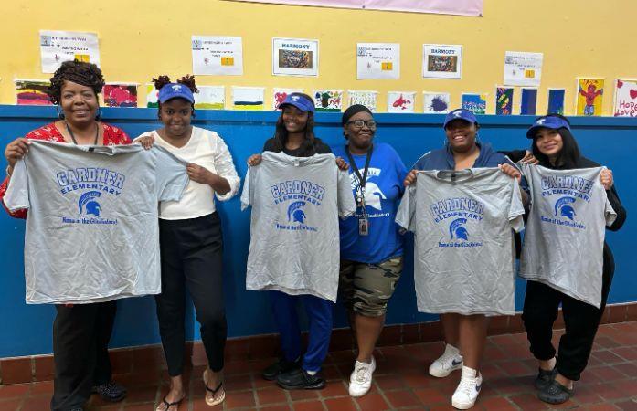 PTA members holding school shirts